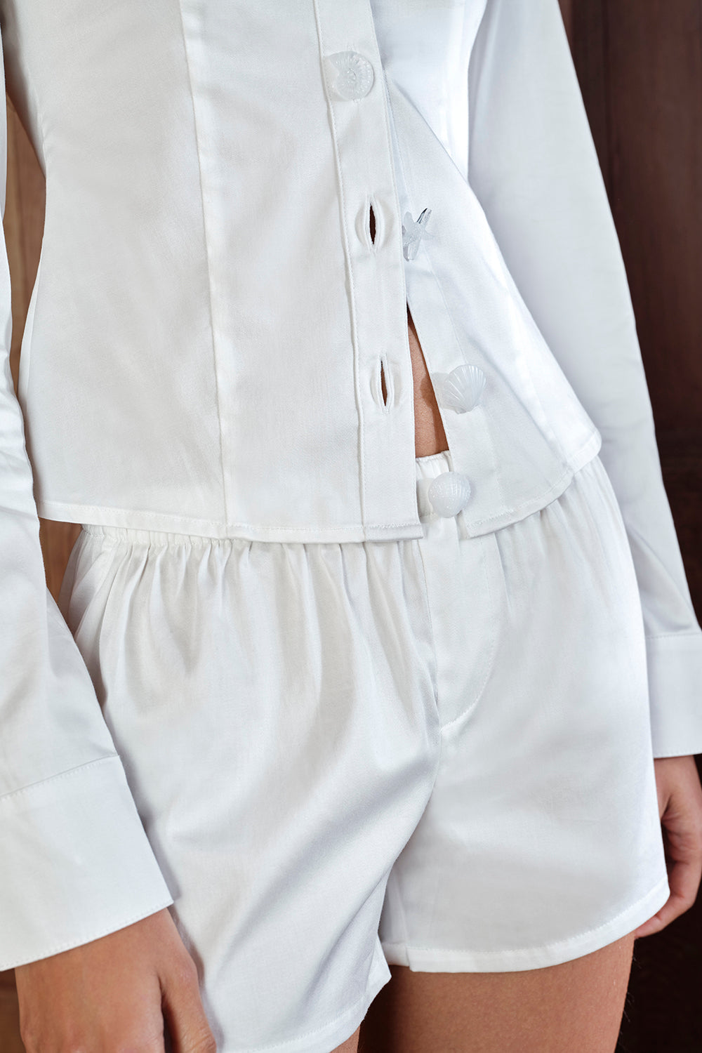 White shirt and shorts set on a plain background |M1