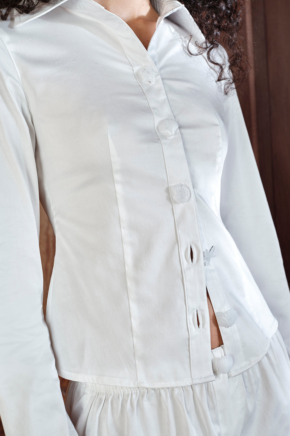 Close-up of a white button-up shirt with a blurred background |M1